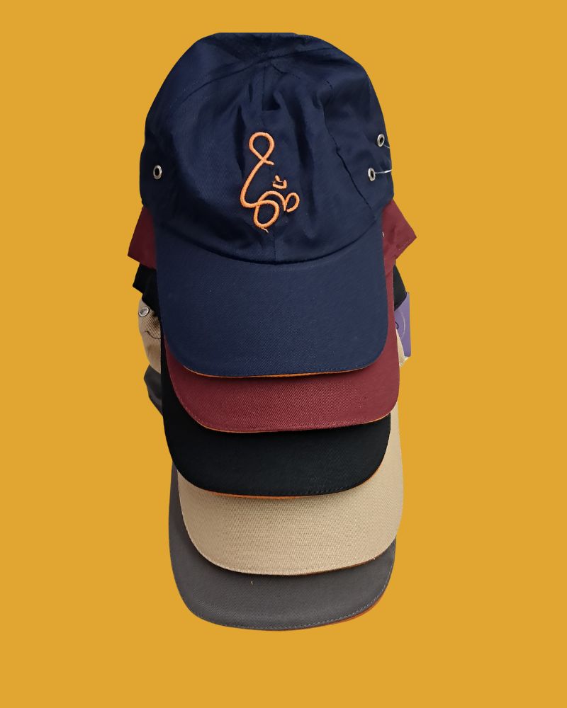 Stack of colorful cotton baseball caps with orange om embroidery